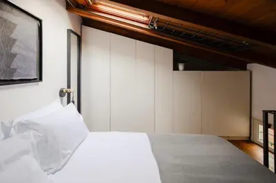 a bedroom with a white bed and white cabinets at Casa Piccinino in Rome