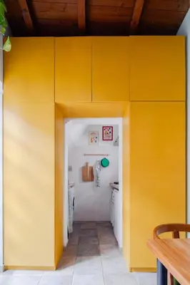 a room with yellow walls and a table at Casa Piccinino in Rome