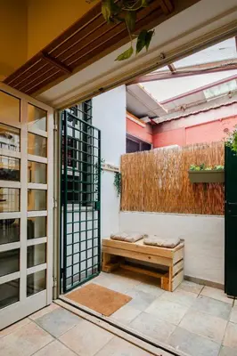 a patio with a bench in front of a building at Casa Piccinino in Rome