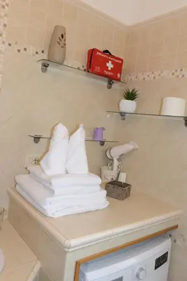 a pile of towels sitting on a counter in a bathroom at Locazione turistica di Carlo in Rome
