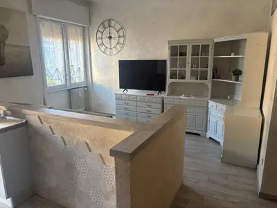 a large living room with a television and a staircase at Locazione turistica di Carlo in Rome