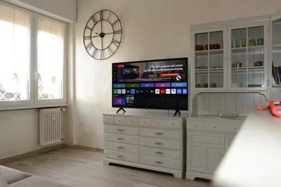 a living room with a flat screen tv on a dresser at Locazione turistica di Carlo in Rome