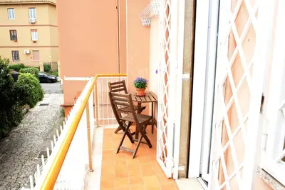 a balcony with a table and a chair at Locazione turistica di Carlo in Rome