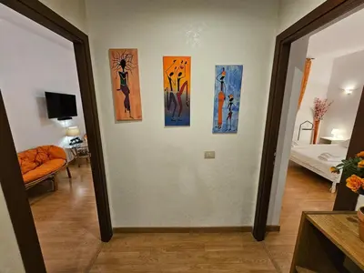a hallway with four paintings on a wall at Private SPA Apartment in Rome in Rome