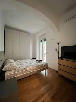 a bedroom with a large bed and a television at Zaffiro Esquilino charming apartment in Rome