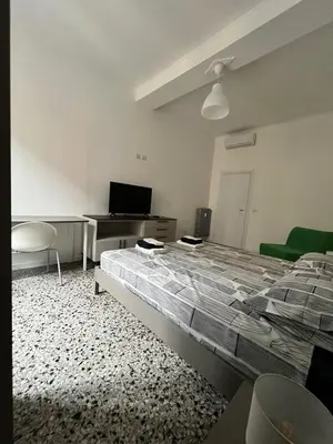a bedroom with a bed and a desk and a television at Zaffiro Esquilino charming apartment in Rome