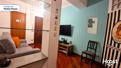a living room with a couch and a tv at Poetry House in Rome