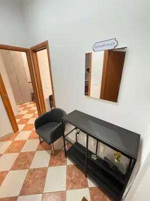 a room with a table and a chair and a mirror at Residenza Abat-Jour de Rome in Rome