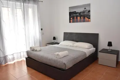a bedroom with a bed with two towels on it at Metro Battistini- D'Alessandro Holiday Home in Rome