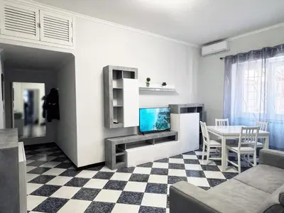 a living room with a tv and a table at Metro Battistini- D'Alessandro Holiday Home in Rome