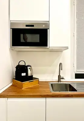 a kitchen with a sink and a microwave at The Temple Apartment in Rome