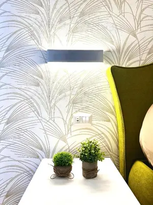 two potted plants on a table next to a couch at The Temple Apartment in Rome