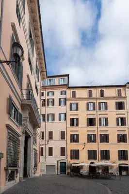 a large tan building with a lot of windows at The Temple Apartment in Rome