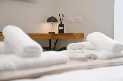 a close up of two white wii controllers on a bed at Appia Luxury Apartment in Rome