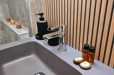 a bathroom sink with a soap dispenser on it at Appia Luxury Apartment in Rome
