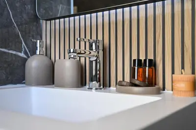 a bathroom counter with a sink with a faucet at Appia Luxury Apartment in Rome