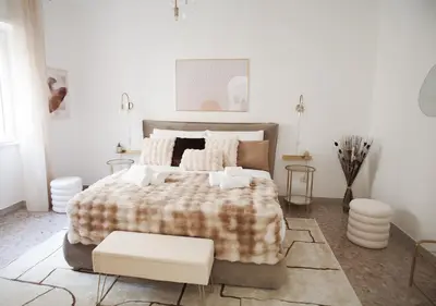 a bedroom with a large bed with a blanket at Thery House - Tiburtina Apartment in Rome