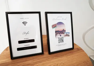 two framed certificates sitting on top of a table at Thery House - Tiburtina Apartment in Rome