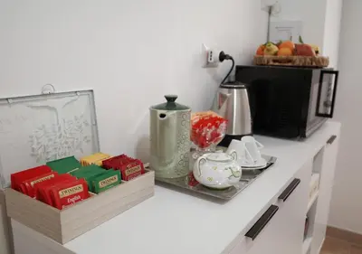 a counter top with a tea set on it at Thery House - Tiburtina Apartment in Rome