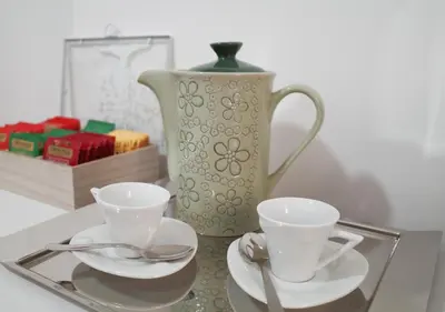 a glass tray with two cups and a vase at Thery House - Tiburtina Apartment in Rome