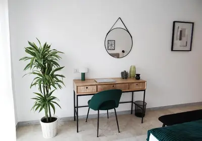 a room with a desk and a chair and a mirror at Thery House - Tiburtina Apartment in Rome