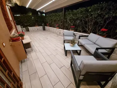 an outdoor patio with couches and tables and plants at Domus de Core in Rome