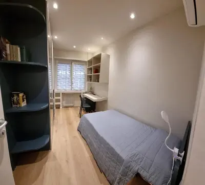 a bedroom with a bed and a desk in it at Domus de Core in Rome