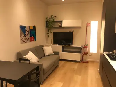 a living room with a couch and a flat screen tv at Domus de Core in Rome