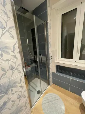 a bathroom with a shower with a glass door at Domus de Core in Rome