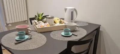 a table with two chairs and two cups on it at Domus de Core in Rome