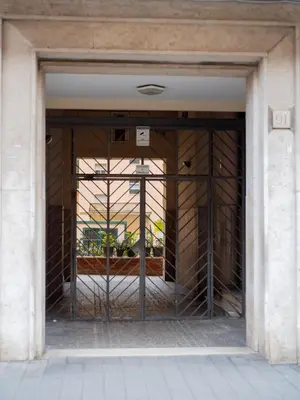 an entrance to a building with a metal gate at casa di Nadia in Rome