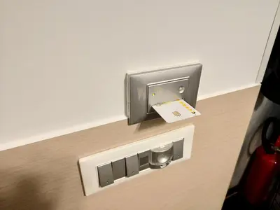a hotel room with a pay phone in a box at Appartamento in Via dei 3 Pupazzi 12 in Rome