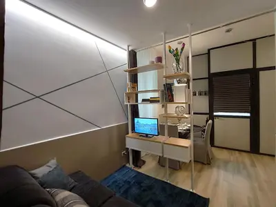 a living room with a couch and a desk with a computer at Appartamento in Via dei 3 Pupazzi 12 in Rome