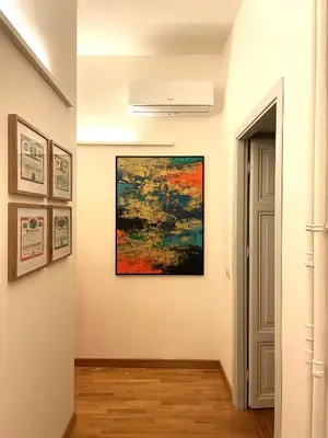 a hallway with a painting on the wall and an open door at Di casa al Colosseo in Rome