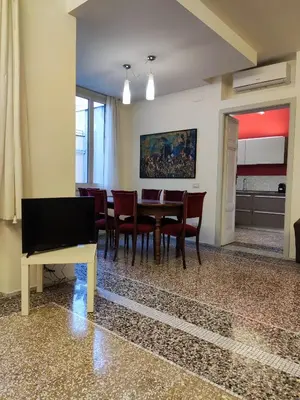 a dining room with a table and chairs at Di casa al Colosseo in Rome