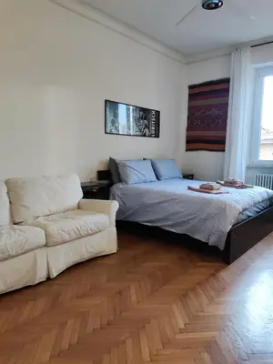 a living room with two beds and a couch at Di casa al Colosseo in Rome
