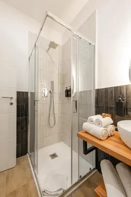 a bathroom with a shower and a sink at Ventuno Dei Luxury Suites San Giovanni in Rome