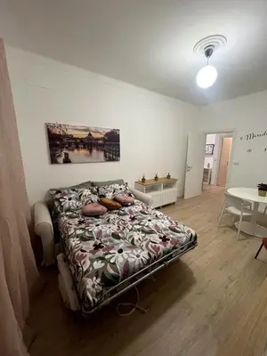 a bedroom with a bed in a room with a table at CAFE Portonaccio apartment in Rome