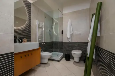 a bathroom with a sink and a toilet and a shower at Trastevere Luxury Studio in Rome