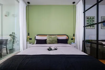 a bedroom with a large bed with two candles on it at Trastevere Luxury Studio in Rome