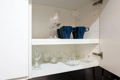 a cupboard with glasses and vases on it at Luxury suite al Vaticano in Rome