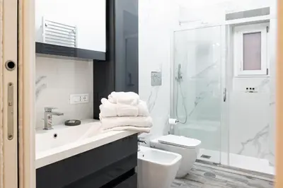 a bathroom with a sink and a toilet and a shower at Luxury suite al Vaticano in Rome