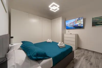 a bedroom with a bed and a tv on the wall at Luxury suite al Vaticano in Rome