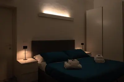 a bedroom with a bed with two stuffed animals on it at Luxury suite al Vaticano in Rome