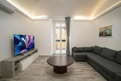 a living room with a couch and a tv at Luxury suite al Vaticano in Rome