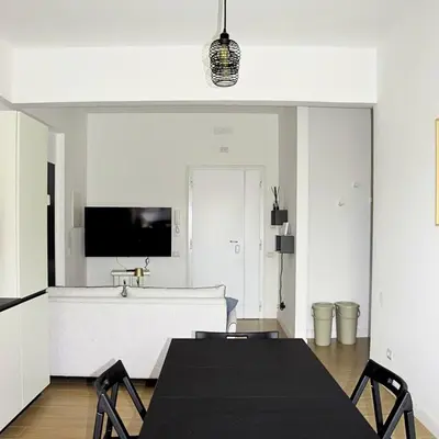 a dining room with a table and a tv at Casa Sisto in Rome