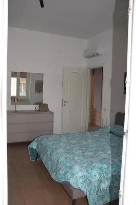 a bedroom with a bed and a bathroom with a sink at Casa Sisto in Rome