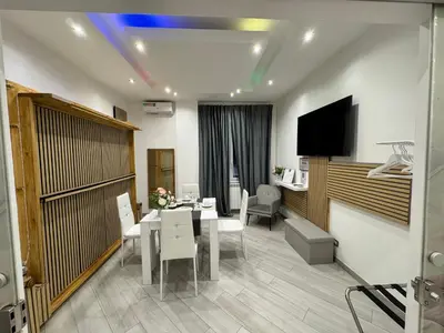 a dining room with a table and chairs and a television at SUITE56Roma in Rome