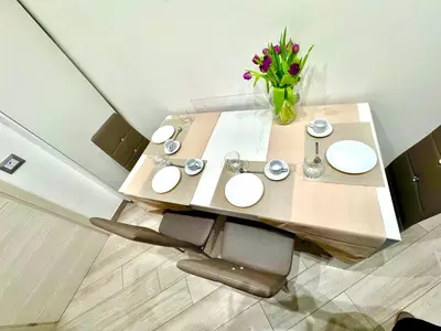 a wooden table with a vase of flowers on it at SUITE56Roma in Rome