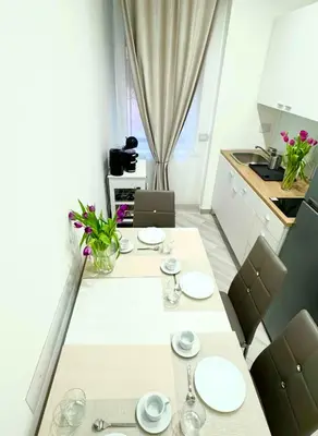a dining room with a white table and chairs at SUITE56Roma in Rome